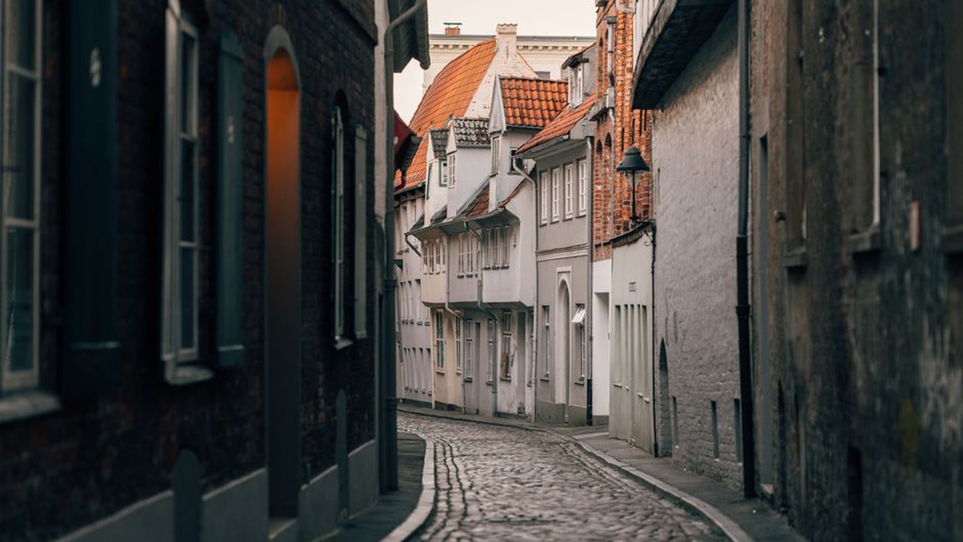 cobblestone alleyway golden temple roof morning in