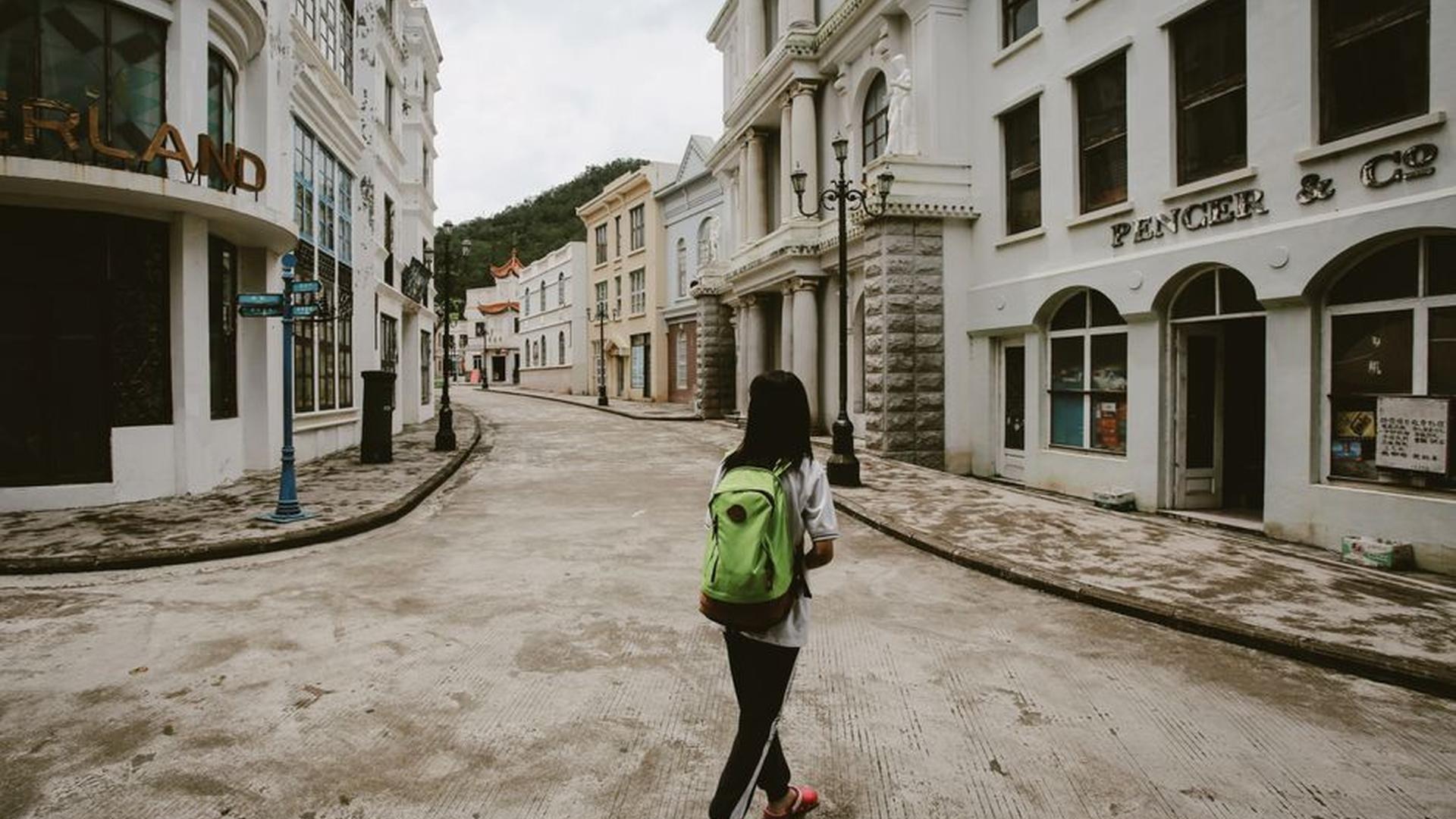 empty backpack city street sunlight quiet traveler